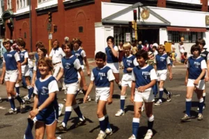 Archival photo of PYSA at a parade in the 1970s - players with retro uniforms