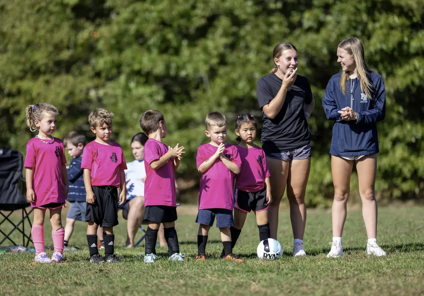 Coaches and team on the sidelines